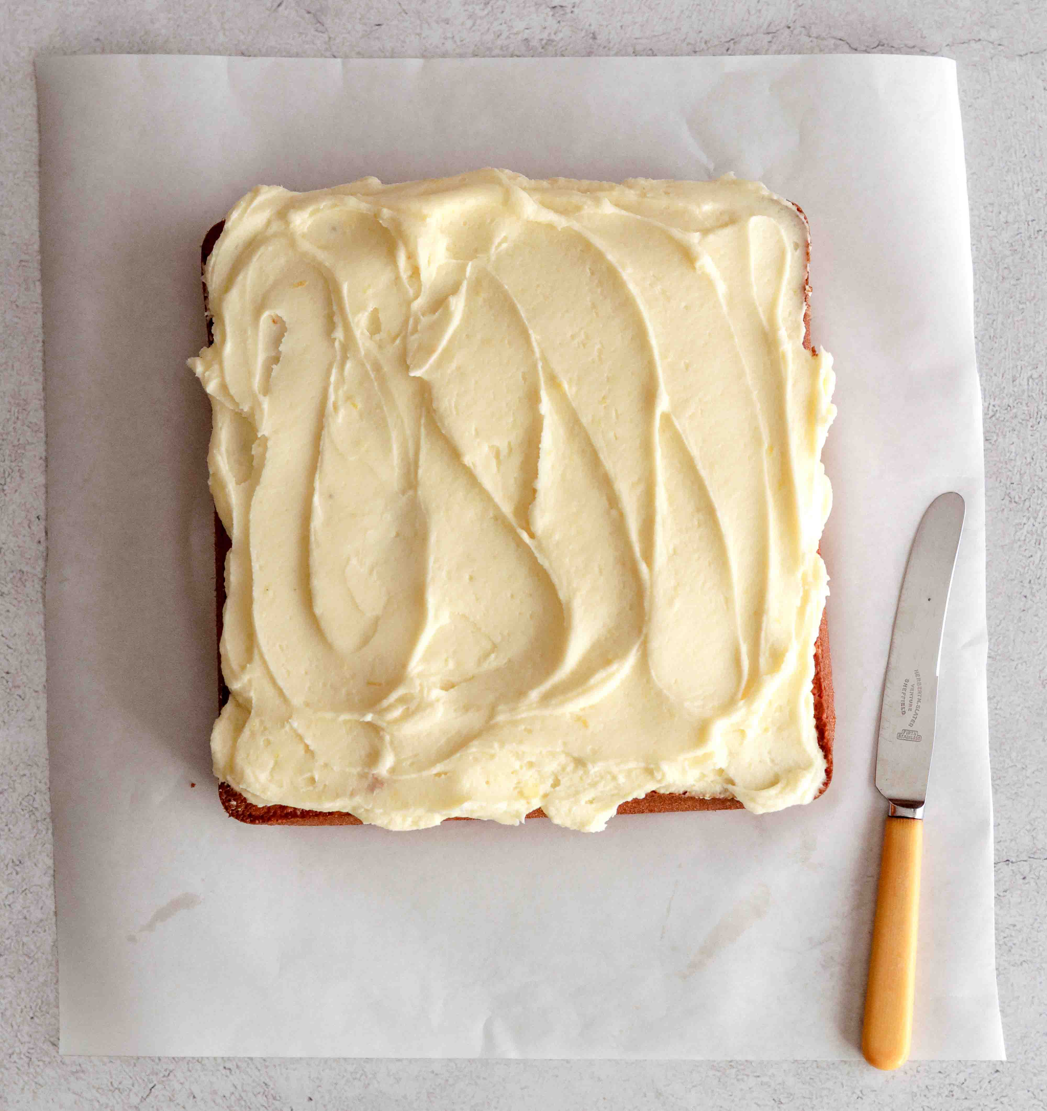 A large square of iced lemon cake