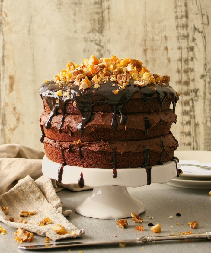 A triple layer vegan chocolate cake with nut brittle.