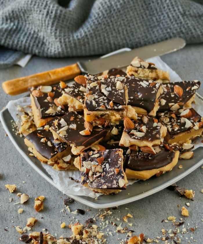 Pieces of fudge with nuts and dark chocolate on a plate. 
