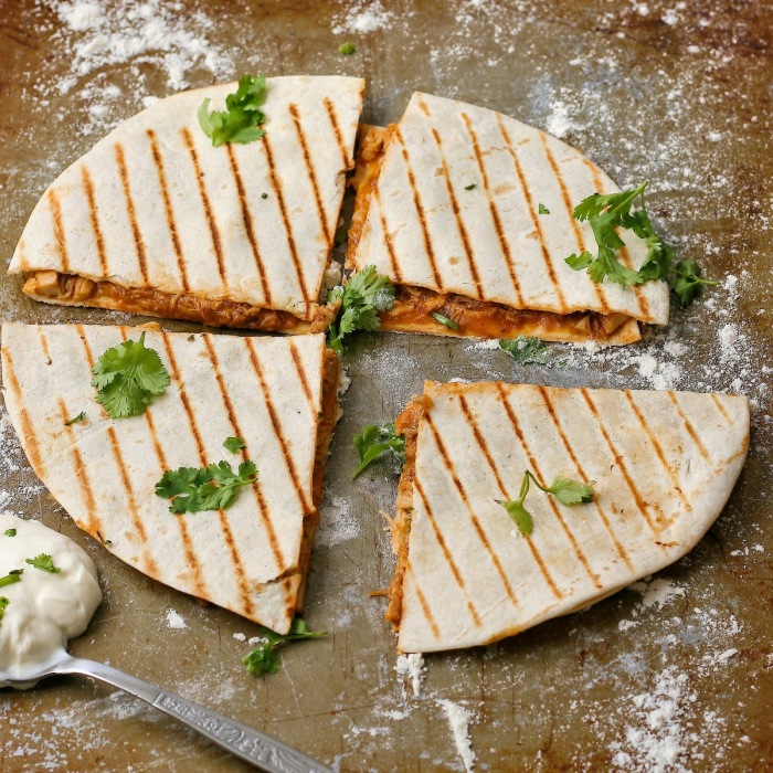 Pulled chicken quesadillas with cheese and coriander. 