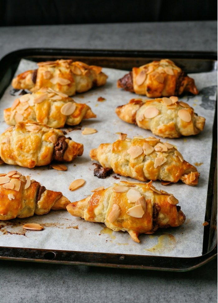 A tray of freshly baked chocolate croissants. 