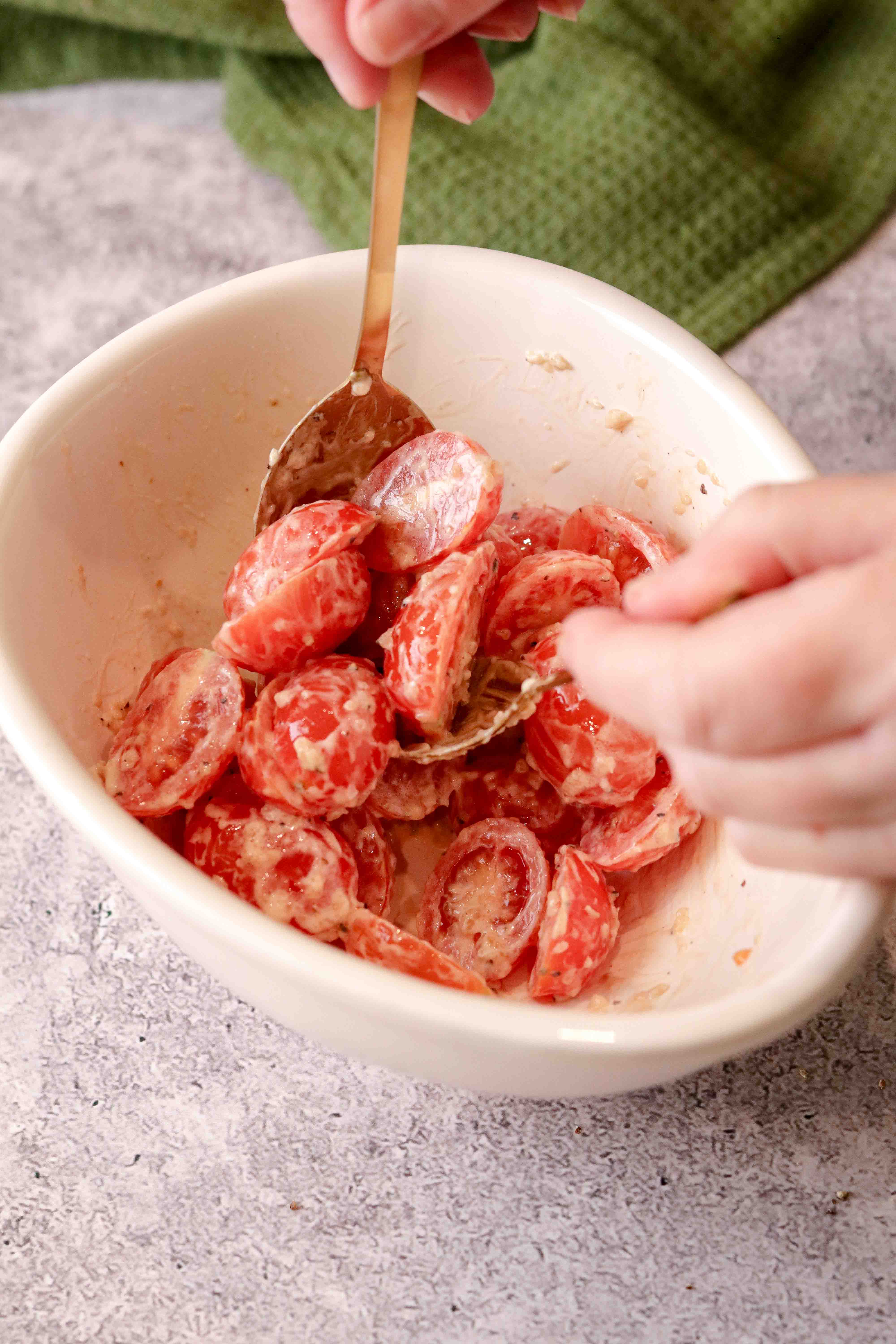 Mixing a bowl of tomatoes