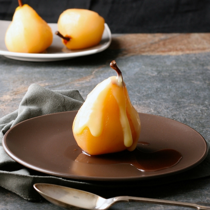 Rosé poached pears in white chocolate sauce. 