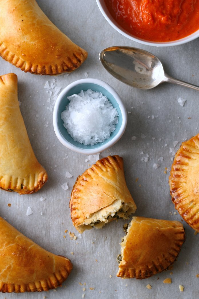 Spinach empanadas with roasted red pepper sauce