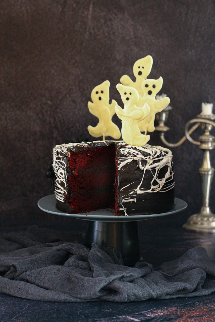 Spider web red velvet cake with chocolate cream cheese icing and chocolate ghosts