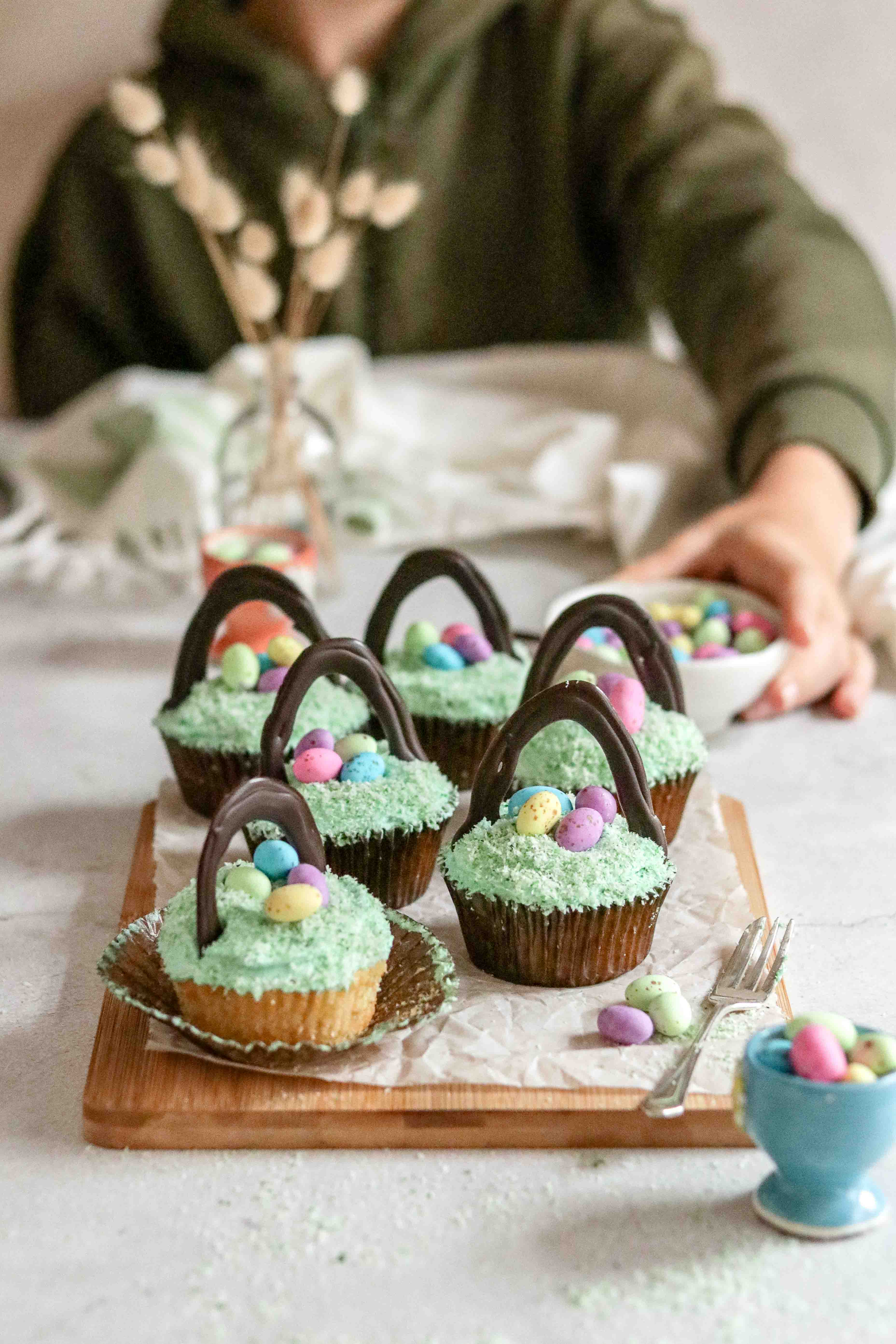 Child picking up an Easter cupcake