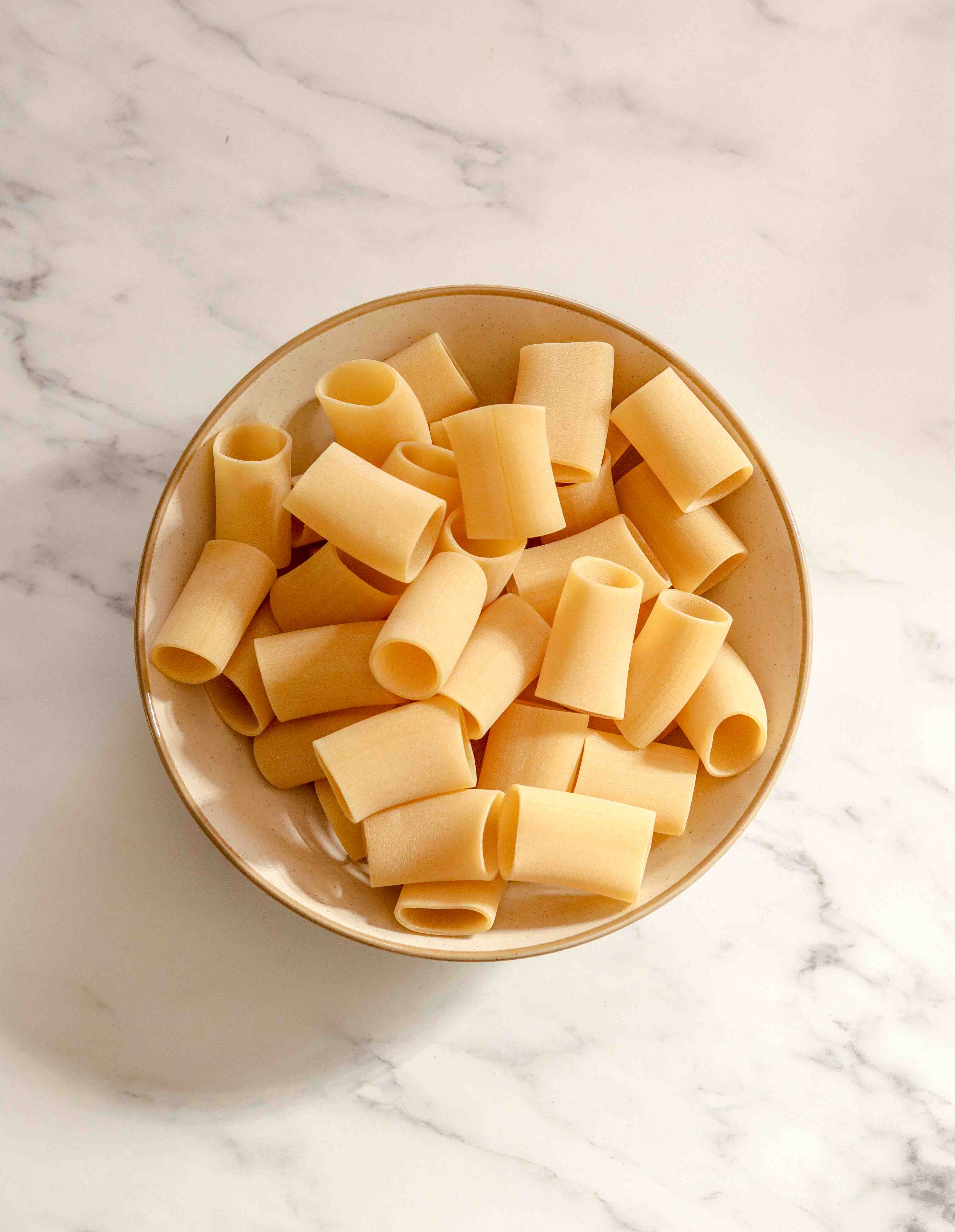 A bowl of large pasta tubes
