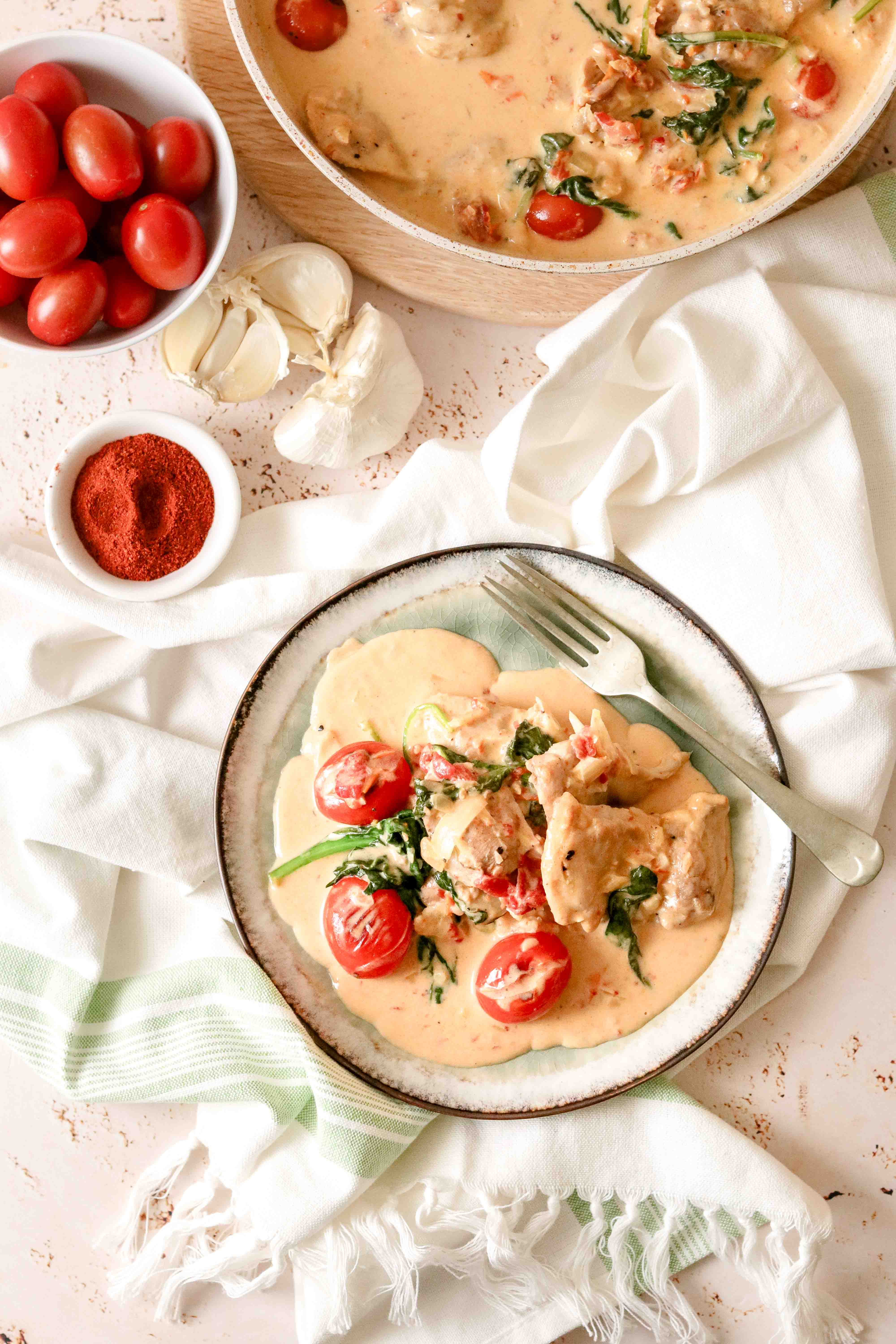 Pan of creamy chicken with tomatoes and parmesan