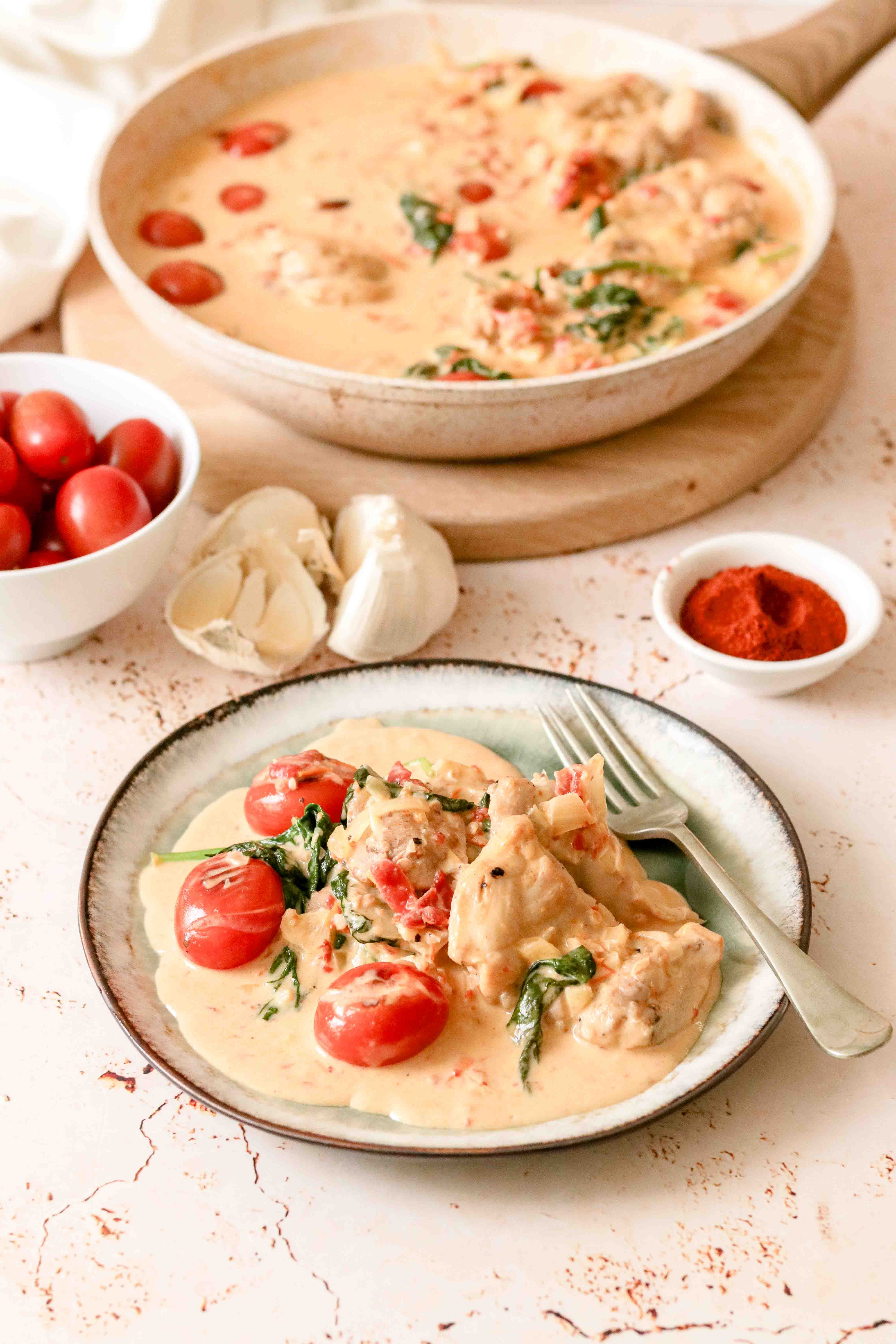 Pan of creamy chicken with tomatoes and parmesan